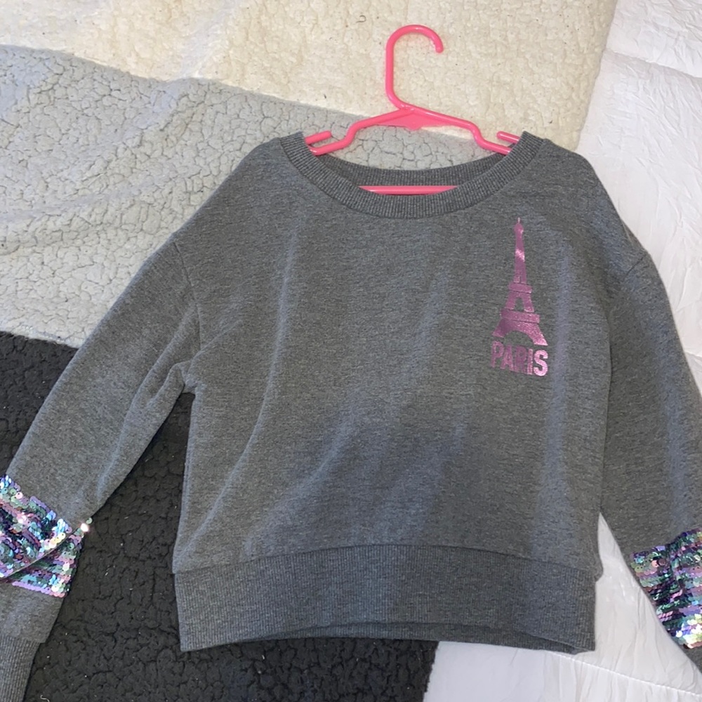 I’m selling a Justice grey sweater.